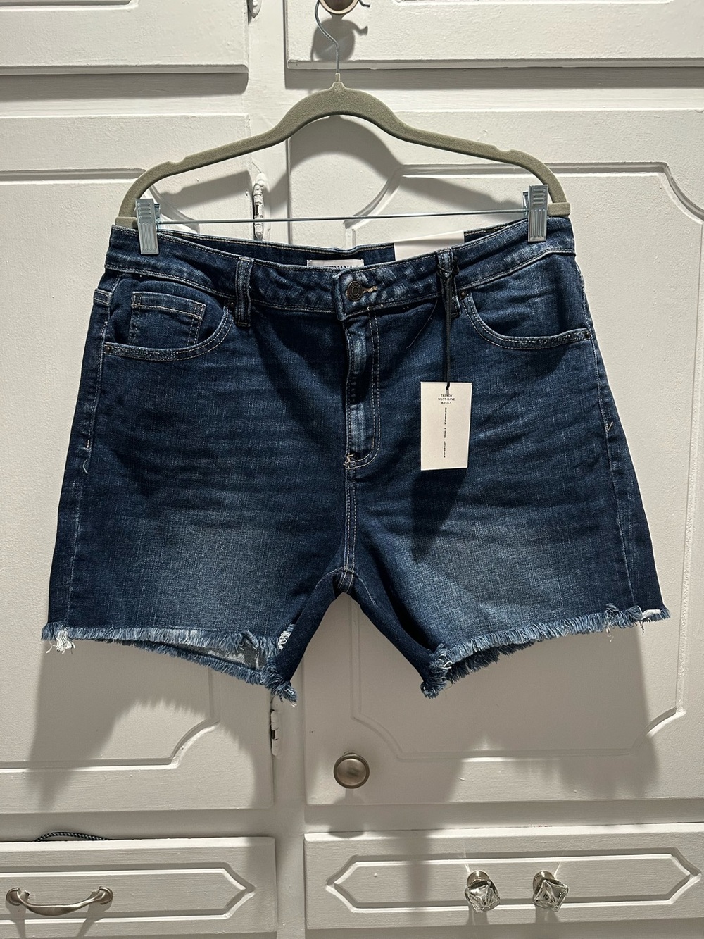 Zenana Washed Frayed Hem denim shorts feature a classic raw hem and dark wash.